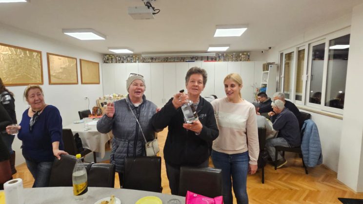 Proslava Vesninog rođendana u udruzi. Vesna, Ivana i Dijana poziraju u sali.